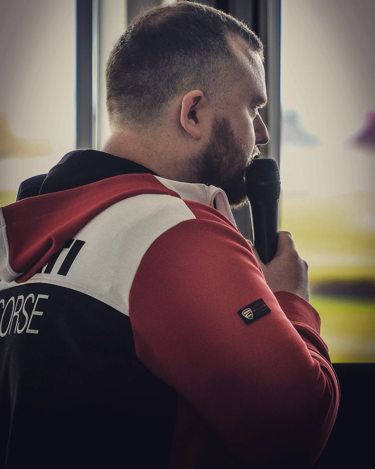 Ben Langford, founder of Marketing Support Partners, speaking into a microphone in a black-and-white photograph